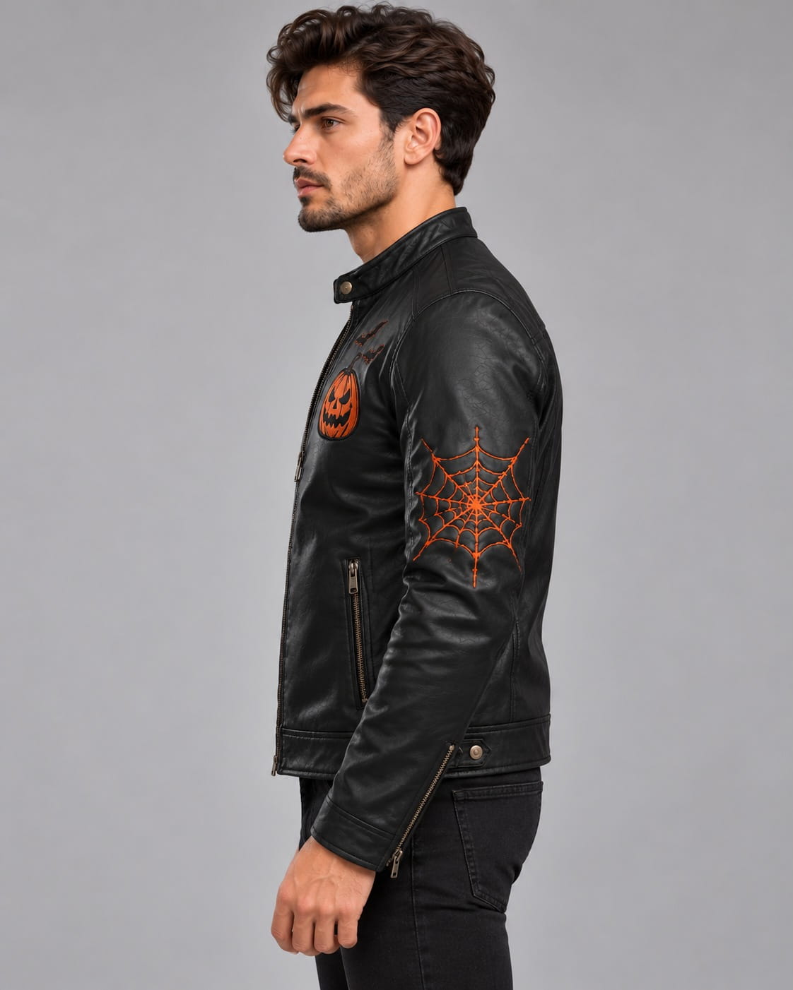 Side view of men’s black Halloween leather biker jacket showing orange spiderweb sleeve artwork