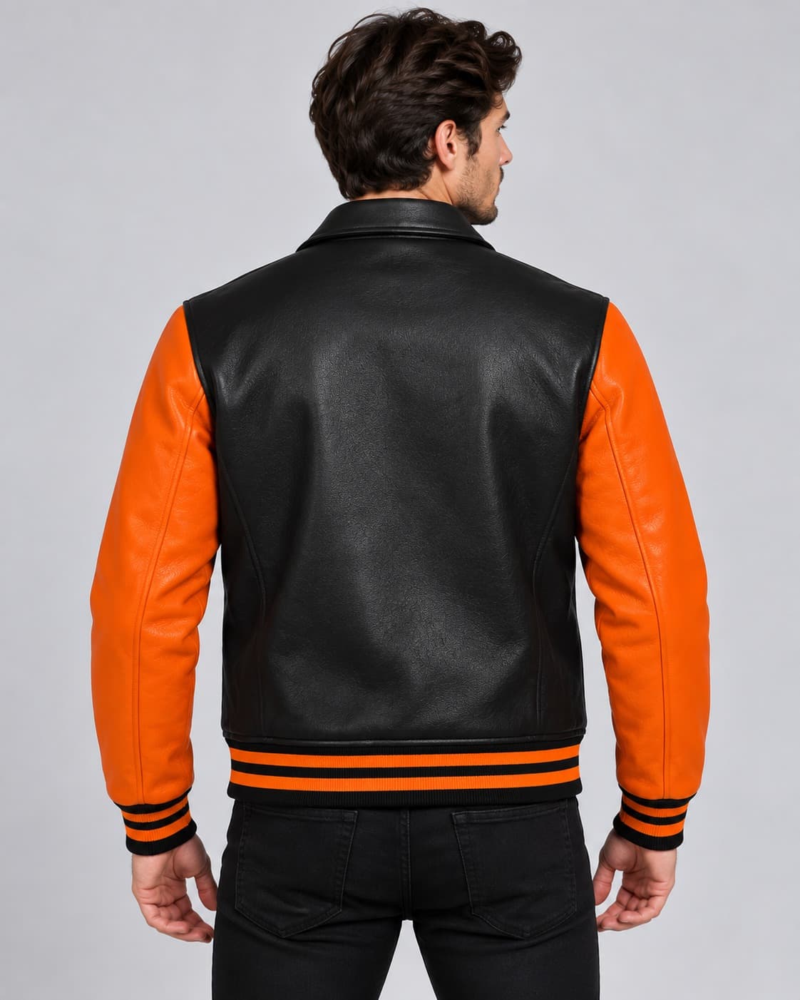 Back view of men’s black and orange genuine leather Halloween varsity jacket