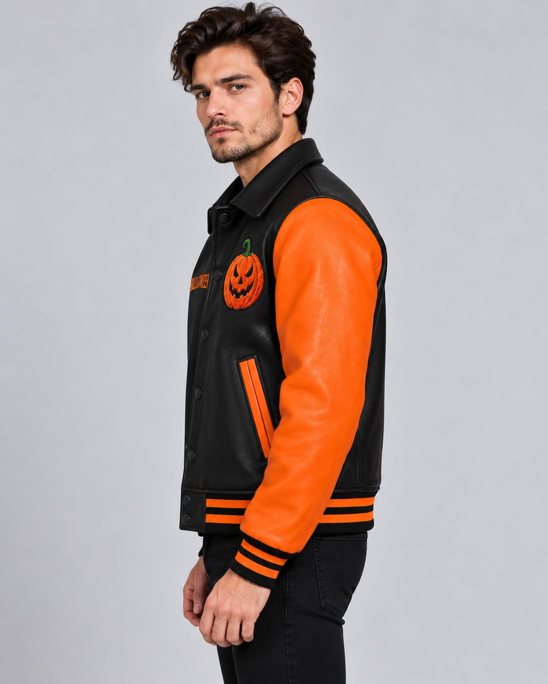 Side view showing orange leather sleeve and black body of men’s Halloween varsity jacket