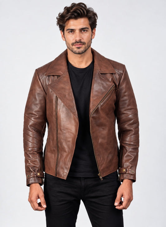 Front view of a model wearing an open cognac brown leather biker jacket over a black t-shirt, featuring wide notch lapels, ribbed sleeve detailing, an asymmetrical front zip, a diagonal chest zip pocket, and snap-tab wrist cuffs.   