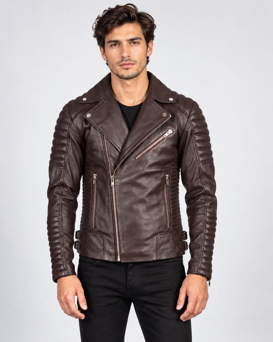 Front view of a model wearing a dark brown leather biker jacket displaying full ribbed arm and side paneling, wide notched lapels with metal snap fasteners, an asymmetrical zip closure, a diagonal zip chest pocket, and dual waist buckle straps.   