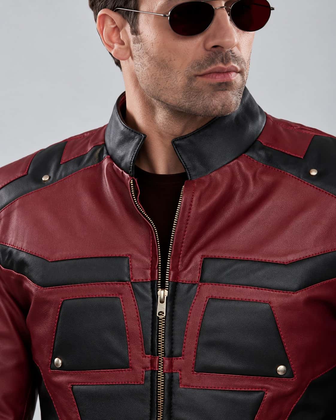 Close-up of the burgundy and black geometric panels, black stand collar, front zipper and metallic details on the Men's Marvel’s Daredevil Charlie Cox Leather Jacket.