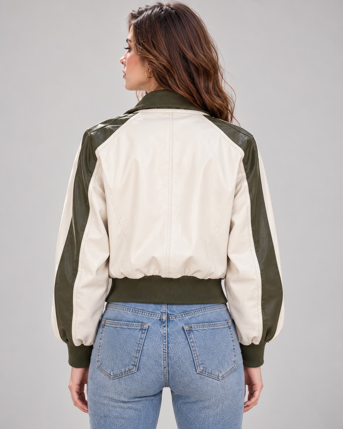 Back view of women's ivory leather bomber jacket with olive green shoulder panels, sleeve panels, and ribbed hem.